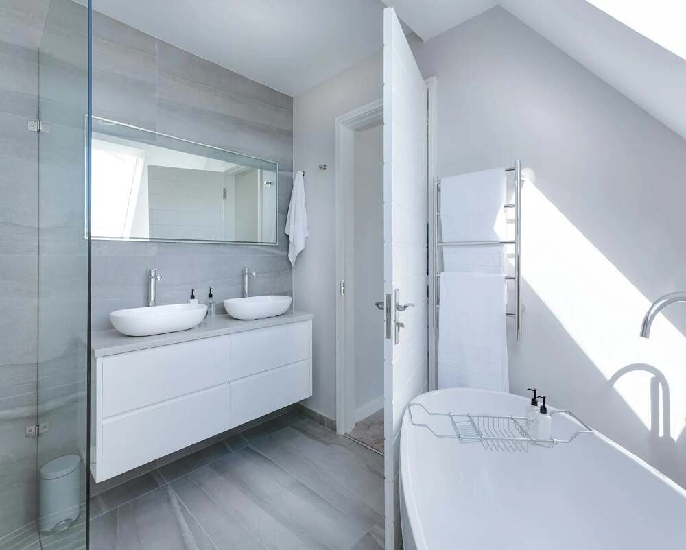 a renovated and remodeled bathroom with a sink and a mirror