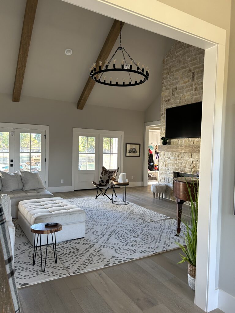 New construction build with vaulted ceilings, exposed beams, beautiful fireplace, large plank handscraped wood floors, and tons of natural light